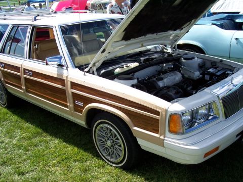 1972 Ford Ranchero - A white station wagon with wood paneling is displayed with its hood up, revealing the engine compartment.