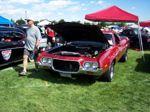 1972 Ford Ranchero - A red 1972 Ford Ranchero is displayed with its hood open at an outdoor car show.