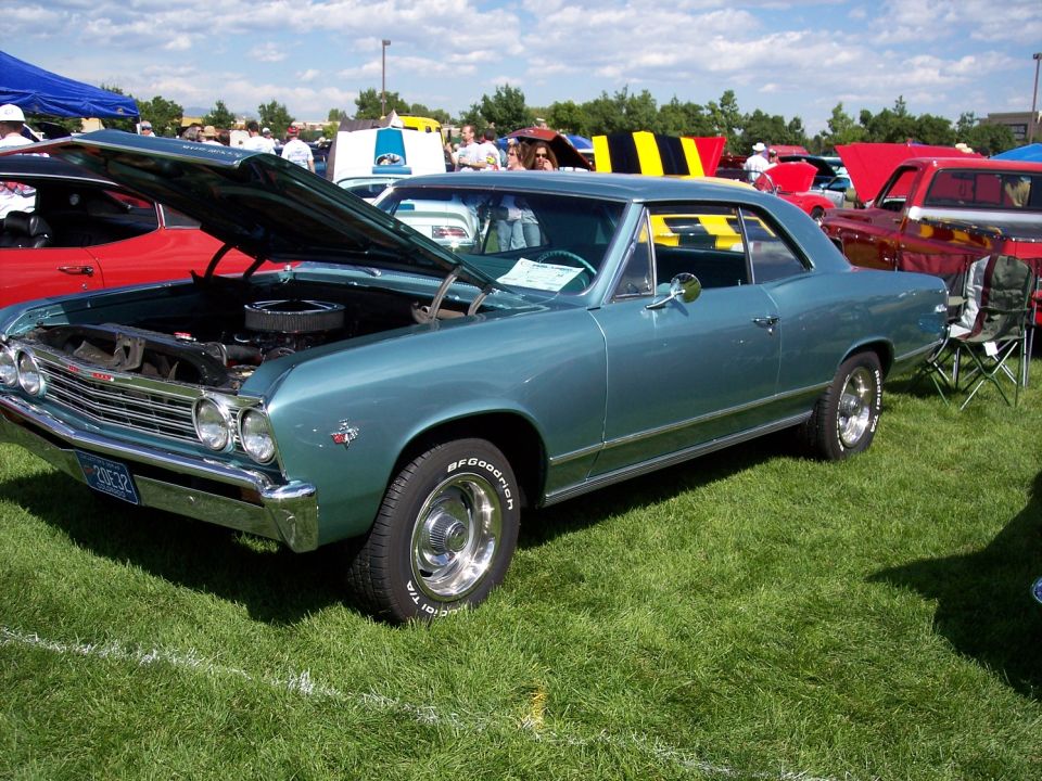 1966 Chevrolet Chevelle coupe with hood open, parked on grass at car show