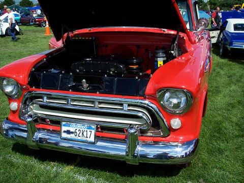 1972 Ford Ranchero - A classic red Chevrolet pickup truck is displayed with its hood open, revealing the engine bay.