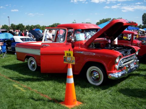 1972 Ford Ranchero - A classic red Chevrolet pickup truck is displayed at an outdoor car show.
