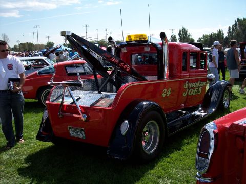 1972 Ford Ranchero - A custom tow truck with a vintage body style is displayed at an outdoor car show.