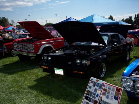 1972 Ford Ranchero - A black coupe, possibly from the 1980s, is displayed with its hood open at an outdoor car show.