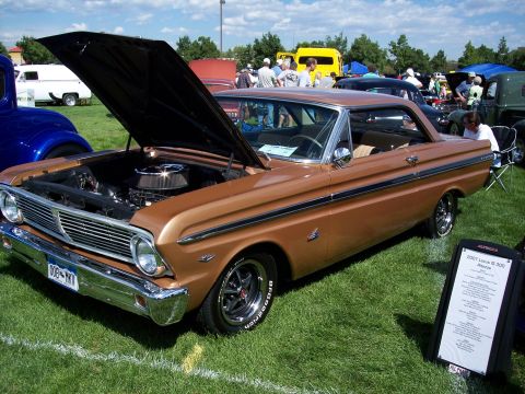 1972 Ford Ranchero - A bronze 1964 Ford Falcon coupe is displayed with its hood open at an outdoor car show.