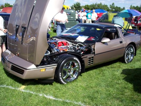 1972 Ford Ranchero - A brown Chevrolet Corvette is displayed with its hood open, revealing the engine and custom modifications.