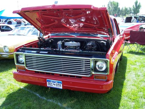 1972 Ford Ranchero - A red pickup truck is displayed with its hood open, revealing the engine compartment.