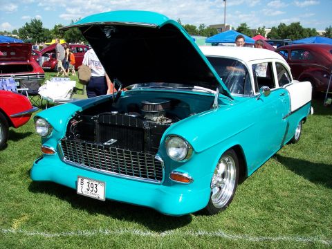 1972 Ford Ranchero - A turquoise and white 1955 Chevrolet sedan delivery is displayed with its hood open, revealing the engine, at an outdoor car show.