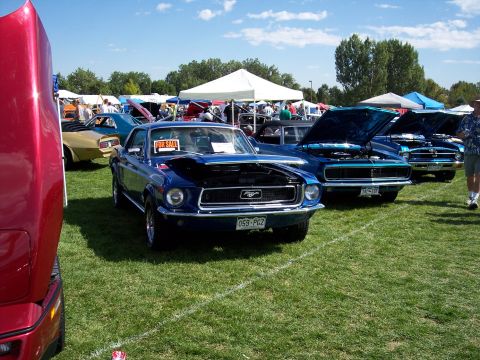 1972 Ford Ranchero - Blue 1969 Ford Mustang at a car show, hood open, with a 'FOR SALE' sign visible.