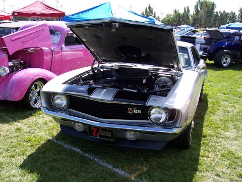 1972 Ford Ranchero - A silver 1969 Chevrolet Camaro Z/28 is displayed with its hood open at an outdoor car show.