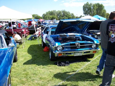 1972 Ford Ranchero - A blue 1970s coupe with its hood open is displayed at an outdoor car show.