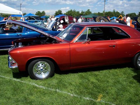 1972 Ford Ranchero - Orange 1966 Chevelle with hood open at an outdoor car show.