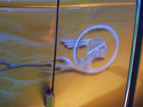 1972 Ford Ranchero - Custom airbrushed artwork a Native American profile within a circular emblem adorns the yellow side panel of a vehicle.