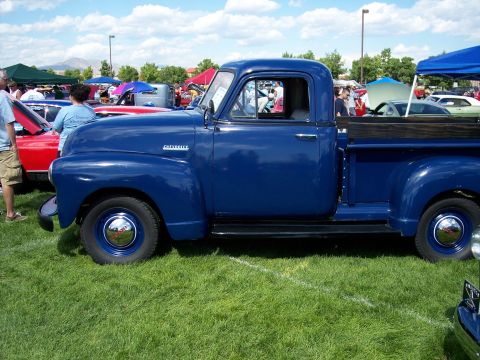 1972 Ford Ranchero - A classic blue Chevrolet pickup truck is displayed at an outdoor event.