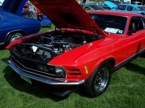 1972 Ford Ranchero - A red 1970 Ford Mustang coupe is displayed with its hood open, revealing the engine bay.