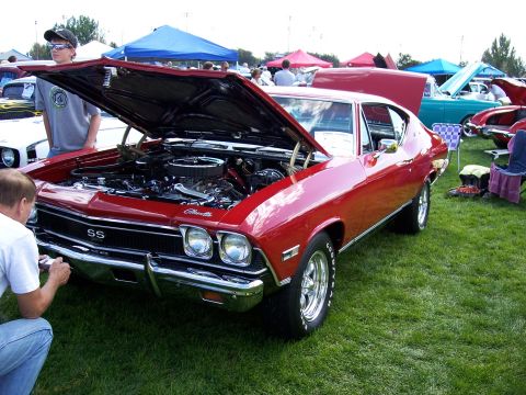 1972 Ford Ranchero - A red 1969 Chevrolet Chevelle SS is displayed with its hood open at an outdoor car show.