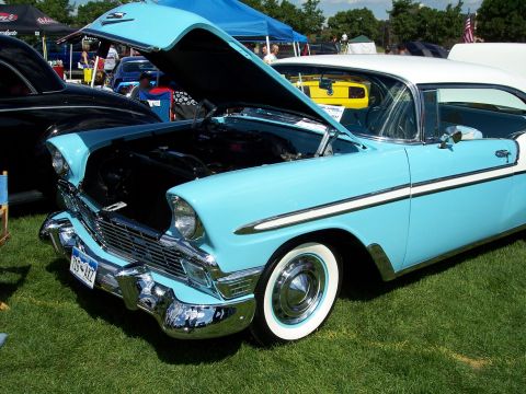1972 Ford Ranchero - A light blue and white 1956 Chevrolet Bel Air is displayed with its hood open at an outdoor car show.