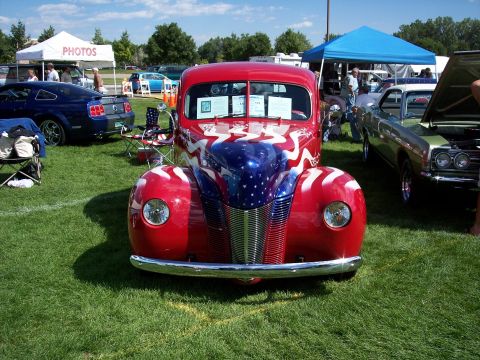 1972 Ford Ranchero - A classic car with patriotic paint is displayed at an outdoor car show.