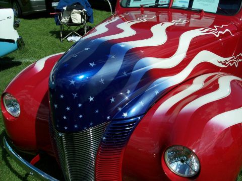 1972 Ford Ranchero - A vintage hot rod displays a patriotic American flag paint job on its hood and fenders.