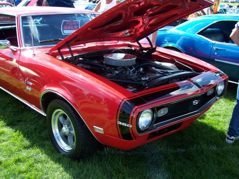 1972 Ford Ranchero - Front view of a red 1969 Camaro SS at a car show, with another car visible behind it.