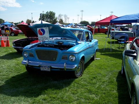 1972 Ford Ranchero - A blue 1959 Studebaker Lark is displayed with its hood open at a car show.