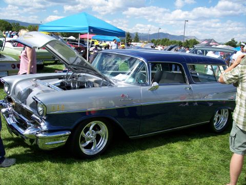 1972 Ford Ranchero - A classic two-tone blue and silver 1957 Chevrolet Nomad is displayed with its hood open at an outdoor car show.