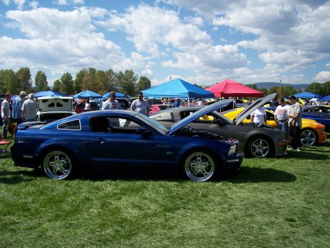 1972 Ford Ranchero - Several cars are on display at an outdoor event, with one blue Mustang GT in the foreground.