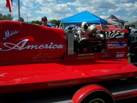 1972 Ford Ranchero - A red boat named 'Miss America' with its engine exposed is displayed on a trailer.