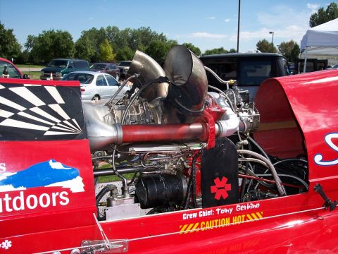 1972 Ford Ranchero - A custom vehicle features a prominent jet engine, with crew and safety information displayed on its red body.
