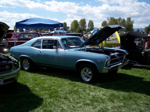 1972 Ford Ranchero - A light blue 1970 Chevrolet Nova coupe is displayed with its hood open at an outdoor car show.