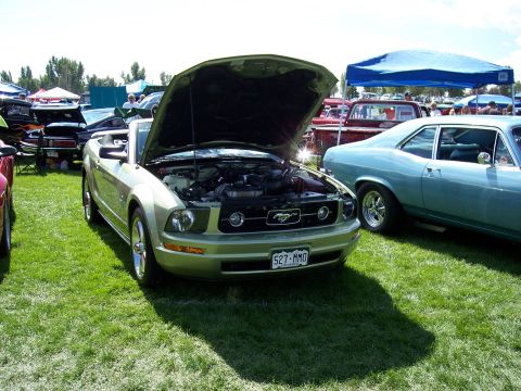 1972 Ford Ranchero - A light green convertible is displayed with its hood open at an outdoor car show.