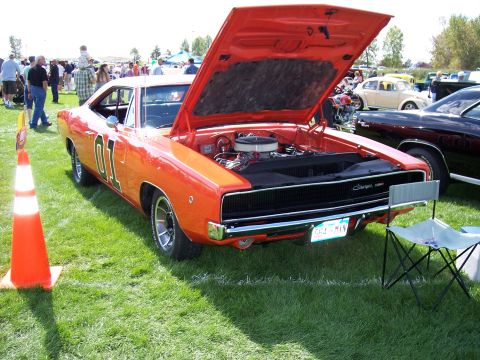 1972 Ford Ranchero - This orange 1969 Dodge Charger, famously known as the General Lee, is displayed with its hood open at an outdoor car show.