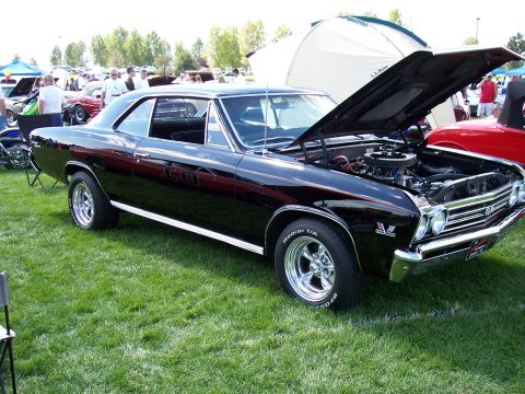 1972 Ford Ranchero - This black 1967 Chevrolet Chevelle SS has its hood open, displaying the engine at an outdoor car show.