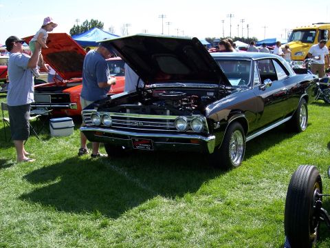 1972 Ford Ranchero - Black 1966 Chevrolet Chevelle SS on display at an outdoor car show event.