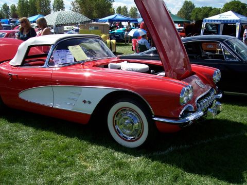 1972 Ford Ranchero - A red 1958 Chevrolet Corvette convertible is displayed with its hood open at an outdoor car show.