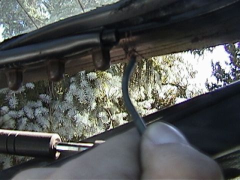 1977 Ford Mustang - Close-up view of a wiring harness near the rear window trim, with the Supermotors logo in the corner.