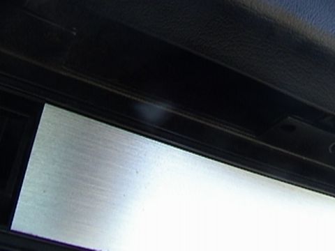 1977 Ford Mustang - Interior trim panel with brushed metal insert and black textured material. Supermotors.net logo visible.