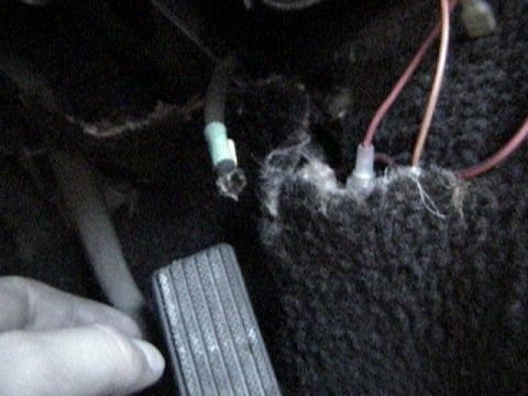 1977 Ford Mustang - Close-up view of interior wiring and a pedal, likely related to electrical issues.