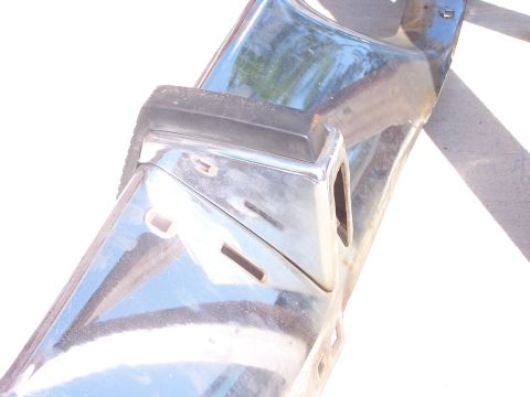 1973 Ford Ranchero - Close-up view of a chrome bumper section black rubber trim and visible mounting points.
