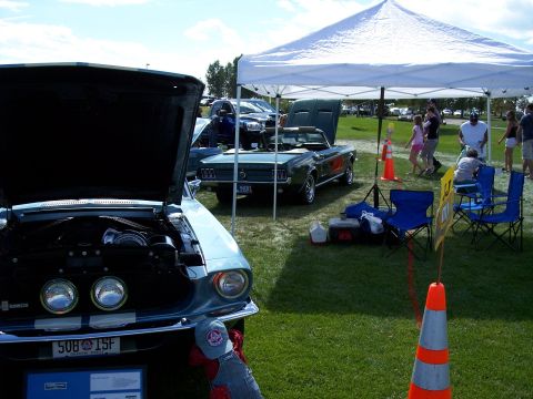 1972 Ford Ranchero - A light blue 1967 convertible is displayed with its hood open, parked next to another vehicle under a white tent.
