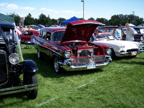 1972 Ford Ranchero - A red 1957 Chevrolet Nomad wagon is displayed with its hood open at an outdoor car show.