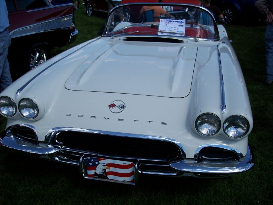 1958 Chevrolet Corvette front view, eagle and flag license plate. Another car is visible to the left