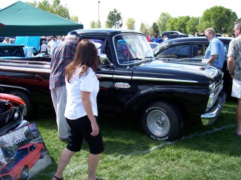 1972 Ford Ranchero - A black 1961 Ford F-100 pickup truck is displayed at an outdoor car show.
