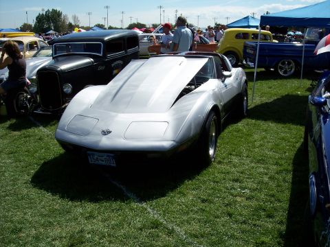 1972 Ford Ranchero - Silver 1975 Corvette C3 at a car show, hood is open revealing the engine bay.