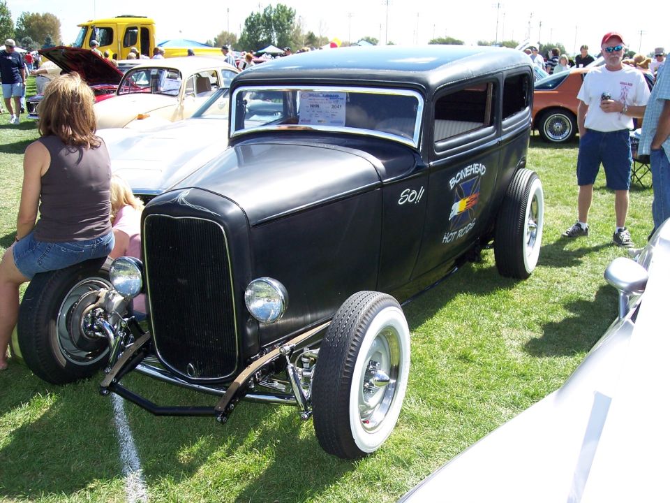 Black hot rod sedan with whitewall tires and 'Bonehead Hot Rod' text on the side