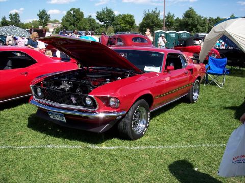 1972 Ford Ranchero - A bright red 1969 Ford Mustang is displayed with its hood up at an outdoor event.