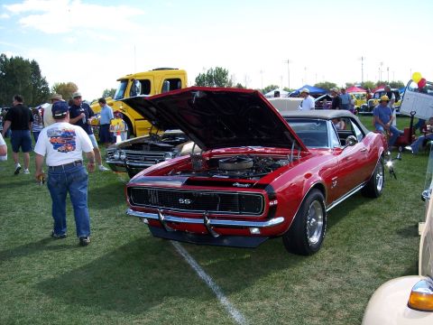 1972 Ford Ranchero - A red 1967 Chevrolet Camaro SS convertible is displayed with its hood open at an outdoor car show.