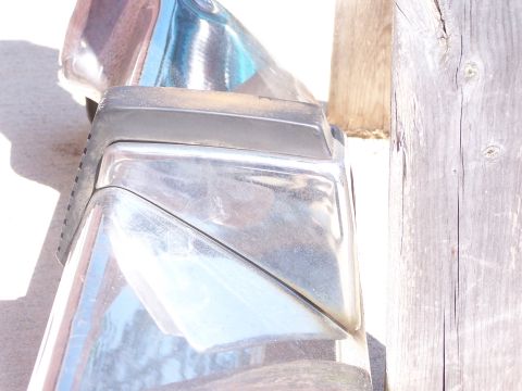 1973 Ford Ranchero - Close-up of a vehicle bumper part, showing chrome and a clear plastic lens.