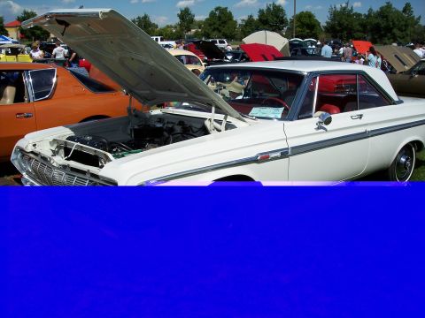 1972 Ford Ranchero - White 1963 Plymouth Belvedere on display at an outdoor car show.