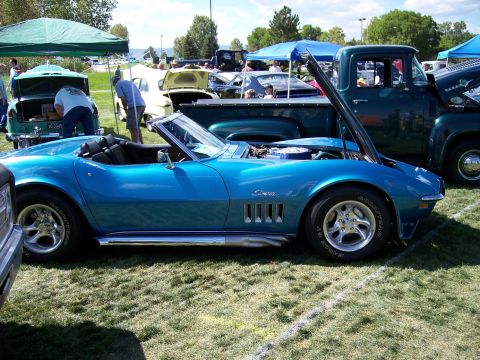 1972 Ford Ranchero - A bright blue 1969 Corvette convertible is displayed with its hood open at an outdoor car show.