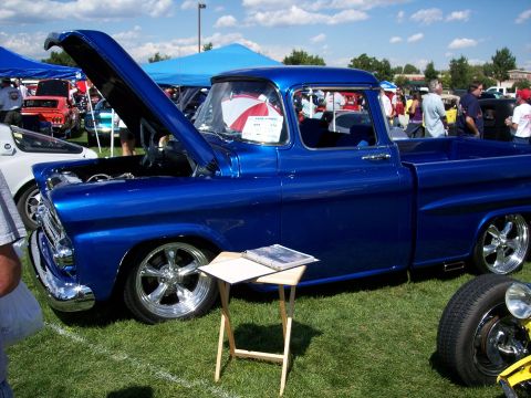 1972 Ford Ranchero - A custom blue pickup truck is displayed at an outdoor car show.